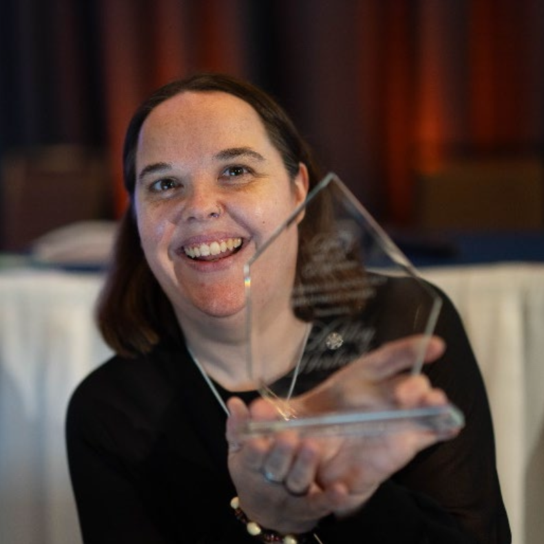 Ashley Herberholz – PDXconnects Portrait of Ashley Herberholz holding an award